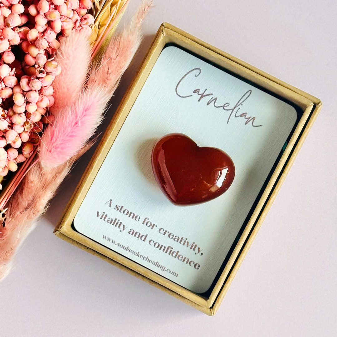 A beautiful ethically mined carnelian heart, presented on an eco-friendly textured card with the words 'A stone for creativity, vitality and confidence.' This heart shaped carnelian crystal measures approximately 25mm x 25mm.