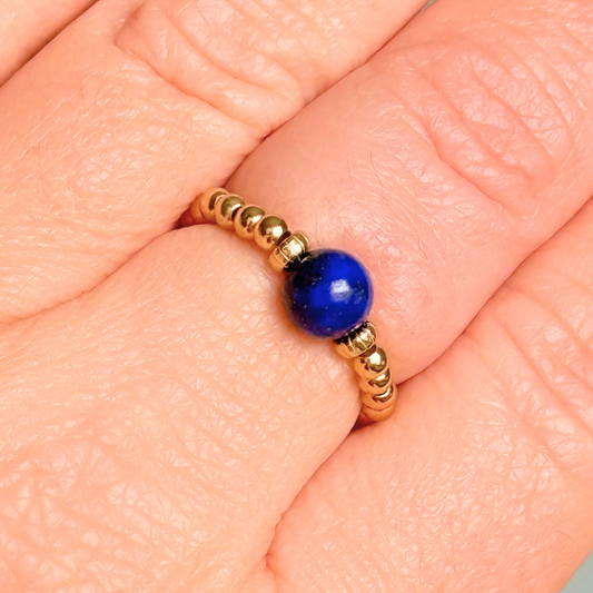 Gold vermeil beaded ring featuring a 6mm lapis lazuli round bead, flanked by gold vermeil corrugated beads. Elasticated for comfort.