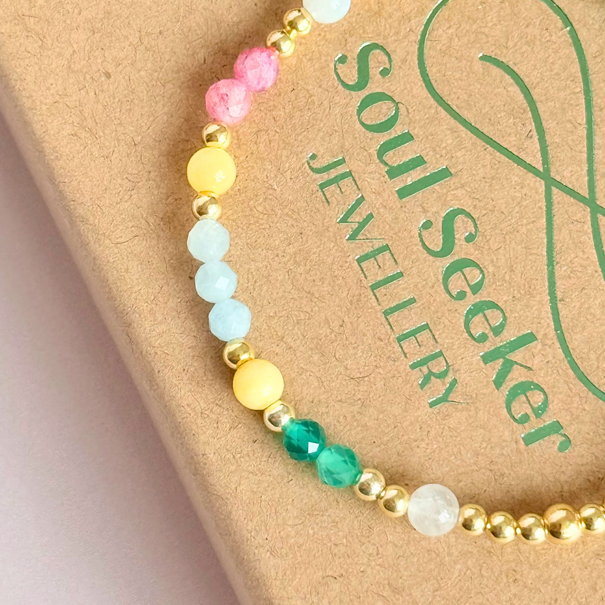 'Amalfi Coast' gold vermeil dainty beaded bracelet with green agate, yellow calcite, pink tourmaline, aquamarine and moonstone. Made with round 3mm gold vermeil beads and 4mm smooth and faceted round crystal gemstone beads. Pictured close up, on the box