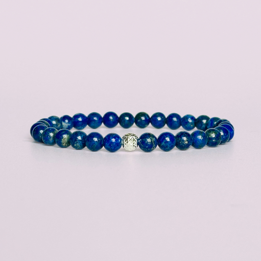 This lapis lazuli bracelet is made with ethically mined lapis lazuli smooth crystal beads and features your choice of a sterling silver or gold vermeil faceted focal bead. All beads are 6mm.
