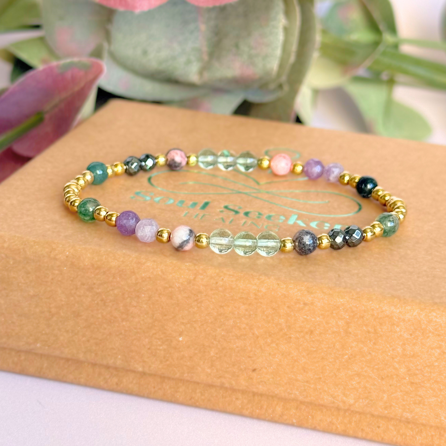 Dainty crystal bracelet featuring five crystals all believed to help with focus, clarity and overwhelm. Featuring fluorite, hematite, lepidolite, moss agate and pink zebra jasper. Featuring 3mm gold vermeil round beads and 4mm faceted round and smooth round crystal beads. Pictured on top of the gift box.￼