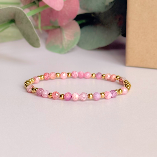 Dainty, minimalist gold vermeil and pink tourmaline October birthstone stacking bracelet. Made with 4mm faceted pink tourmaline beads and 3mm gold vermeil round beads. Elasticated for comfort. Pictured in front of the gift box