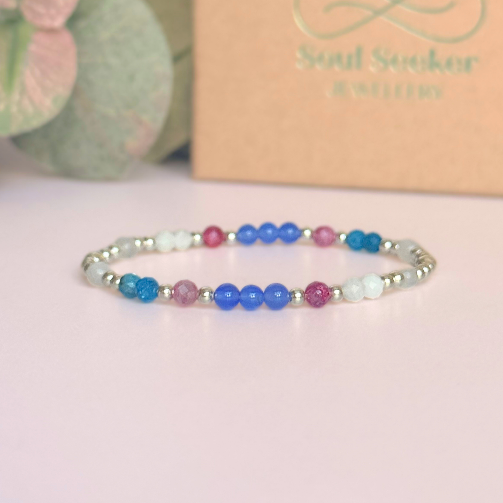 ‘Santorini' sterling silver dainty beaded bracelet with pink tourmaline, rainbow moonstone, blue agate, apatite and white jade. Made with round 3mm sterling silver beads and 4mm smooth and faceted round crystal gemstone beads. Pictured in front of the gift box