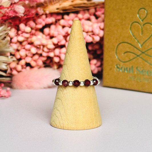 Sterling silver garnet band ring featuring five 3mm faceted round ethically sourced garnet beads, surrounded by sterling silver rondelle beads and delicate 2.5mm sterling silver beads. January birthstone ring.