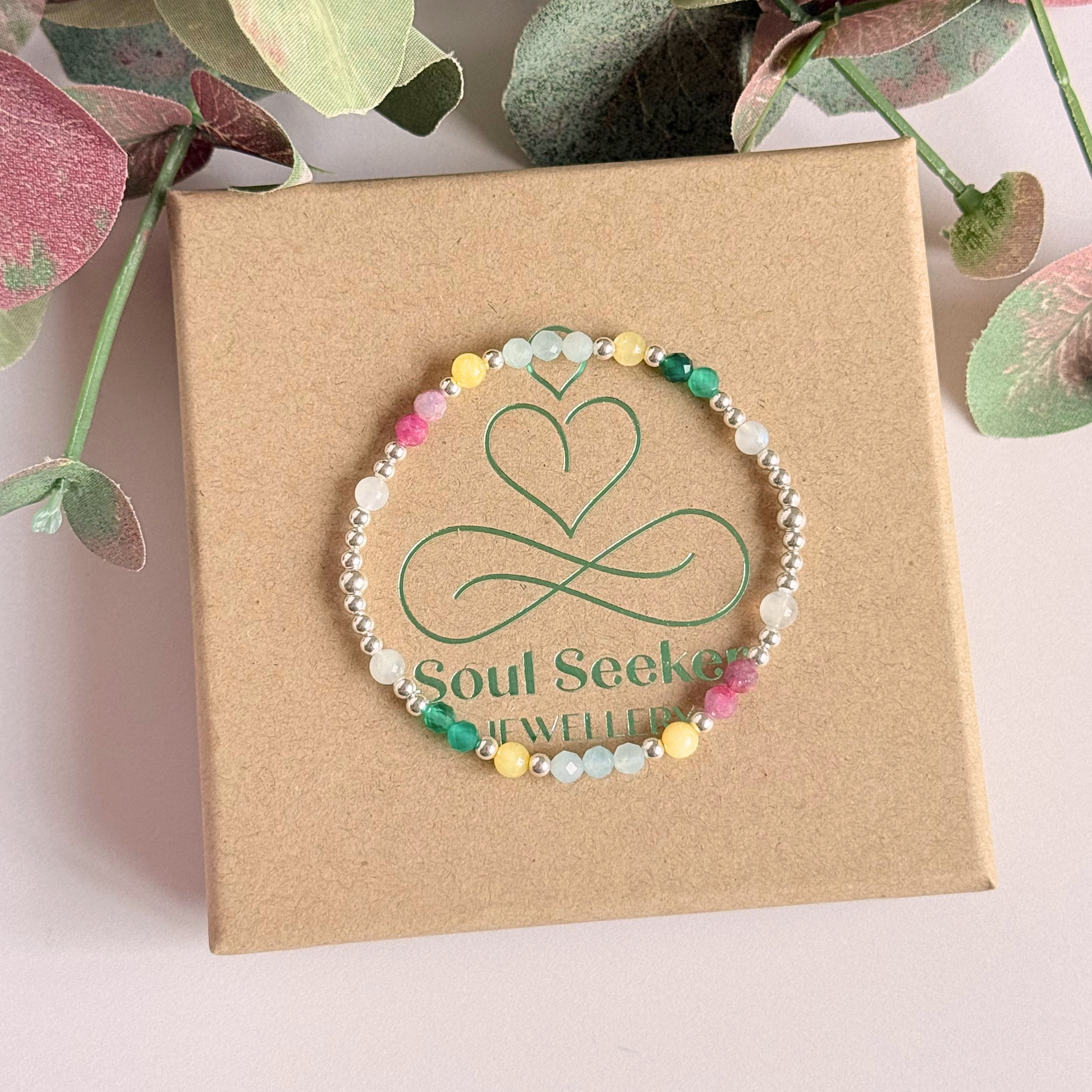 'Amalfi Coast' sterling silver dainty beaded bracelet with green agate, yellow calcite, pink tourmaline, aquamarine and moonstone. Made with round 3mm sterling silver beads and 4mm smooth and faceted round crystal gemstone beads. Pictured on top of the box