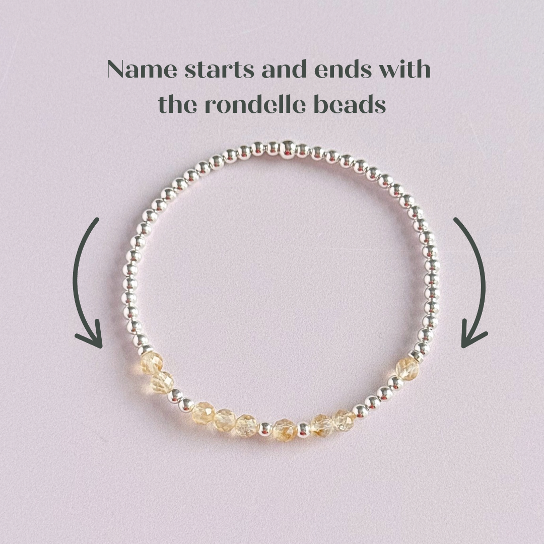 Morse code secret message bracelet spelling out your chosen name in sterling silver and citrine crystal beads. Elasticated with 4mm faceted citrine beads and 3mm sterling silver beads. Custom November birthstone bracelet.