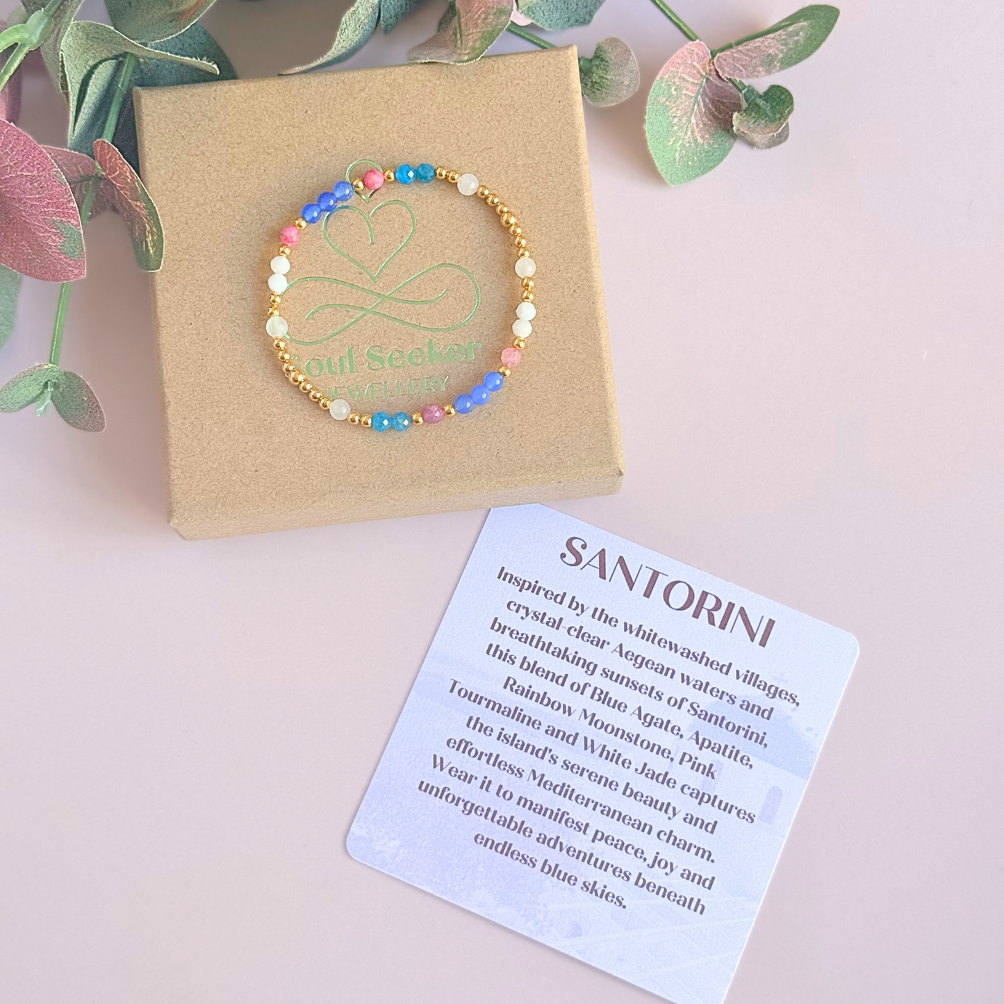 ‘Santorini' gold vermeil dainty beaded bracelet with pink tourmaline, rainbow moonstone, blue agate, apatite and white jade. Made with round 3mm gold vermeil beads and 4mm smooth and faceted round crystal gemstone beads. Pictured on the gift box, with the crystal information card