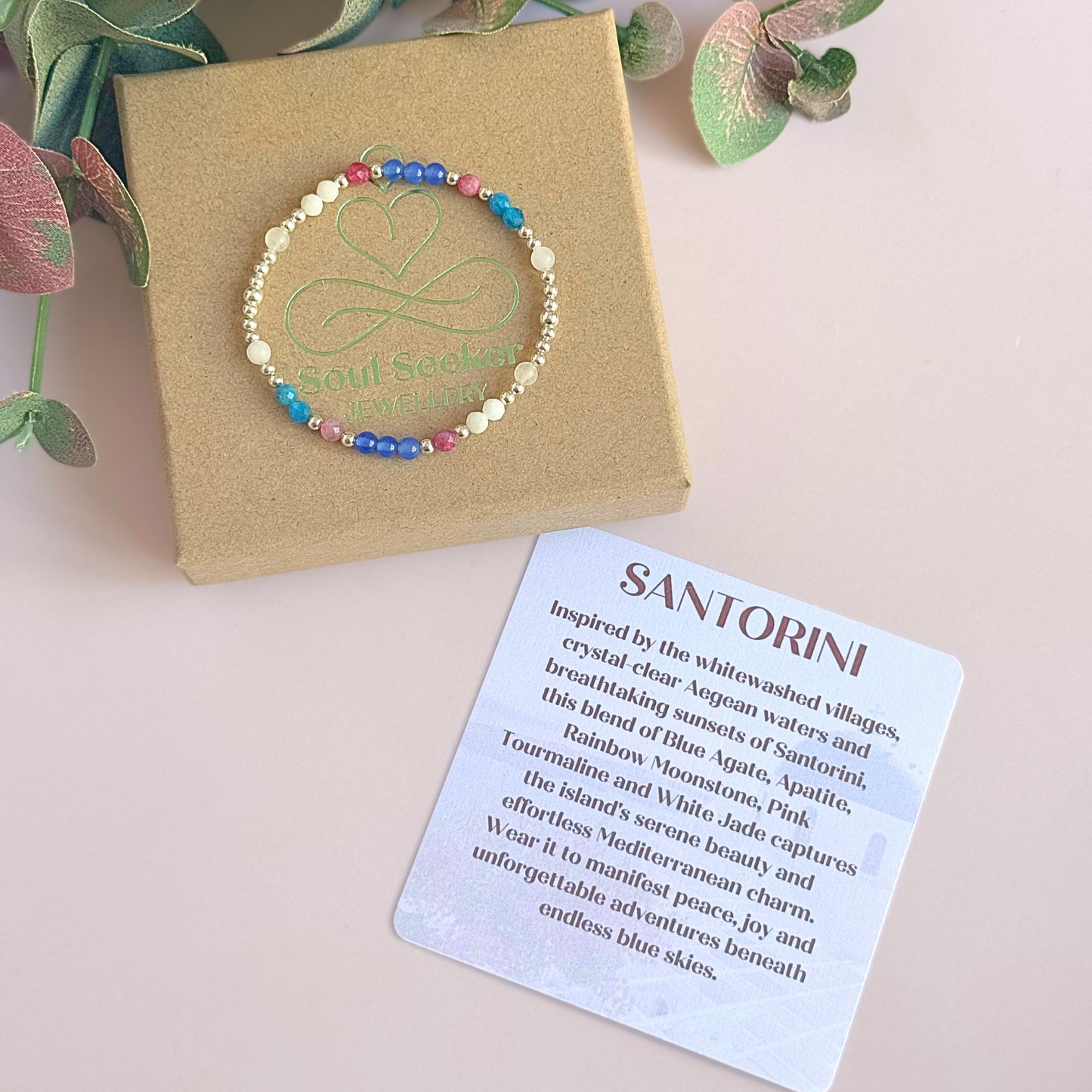 ‘Santorini' sterling silver dainty beaded bracelet with pink tourmaline, rainbow moonstone, blue agate, apatite and white jade. Made with round 3mm sterling silver beads and 4mm smooth and faceted round crystal gemstone beads. Pictured on top of the gift box, with the crystal information card