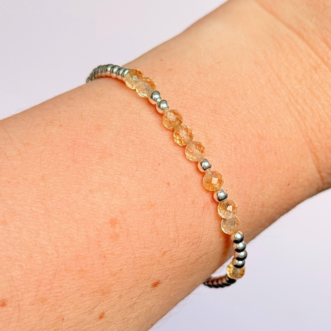 Morse code secret message bracelet spelling out your chosen name in sterling silver and citrine crystal beads. Elasticated with 4mm faceted citrine beads and 3mm sterling silver beads. Custom November birthstone bracelet.