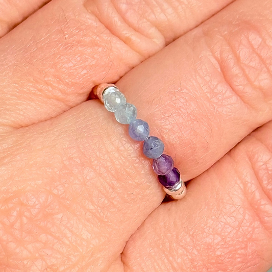 Sterling silver band style ombré ring with multicolour 3mm faceted amethyst tanzanite and aquamarine,  beads with a beaded band of 2.5 mm sterling silver round beads. Elasticated for comfort.