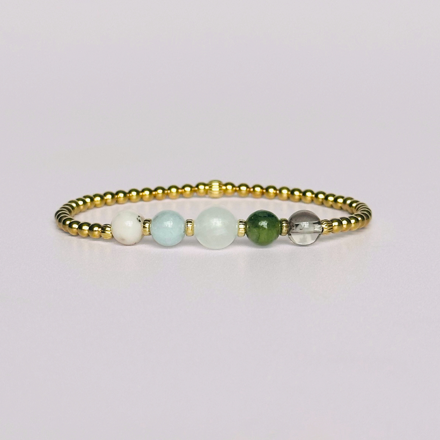 This gold vermeil Virgo bracelet is made with a selection of five healing crystals all believed to resonate with the Virgo zodiac sign. The central bead is 8mm, the other four are 6mm. On an elasticated band of 3mm gold vermeil beads with corrugated accent beads. Featuring amazonite, carnelian, moonstone, moss agate and sardonyx.