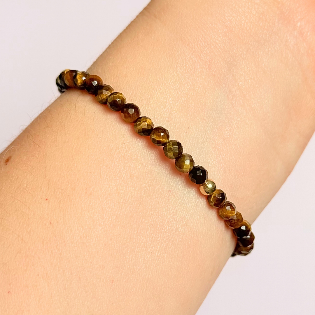 Bracelet featuring 5mm engraved wooden beads, which you can personalise with your choice of words, numbers and symbols. The main the band of the bracelet is made with 4mm faceted tigers eye round crystal gemstone beads. Finished with your choice of gold vermeil, sterling silver or rose gold vermeil accent beads.