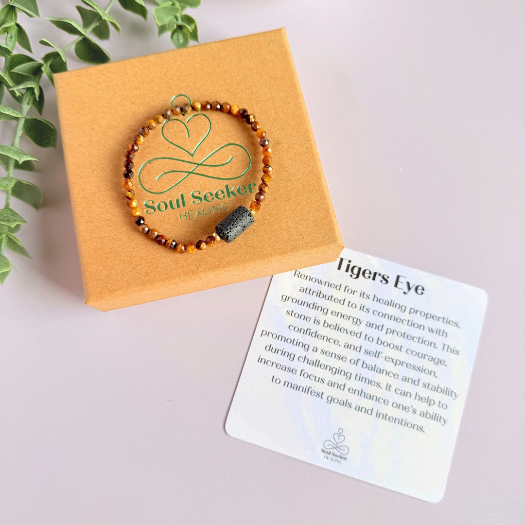 Essential oil diffuser bracelet featuring black lava rock tube bead on the band of 4mm faceted tigers eye beads. Finished with your choice of sterling silver or gold vermeil accent beads.