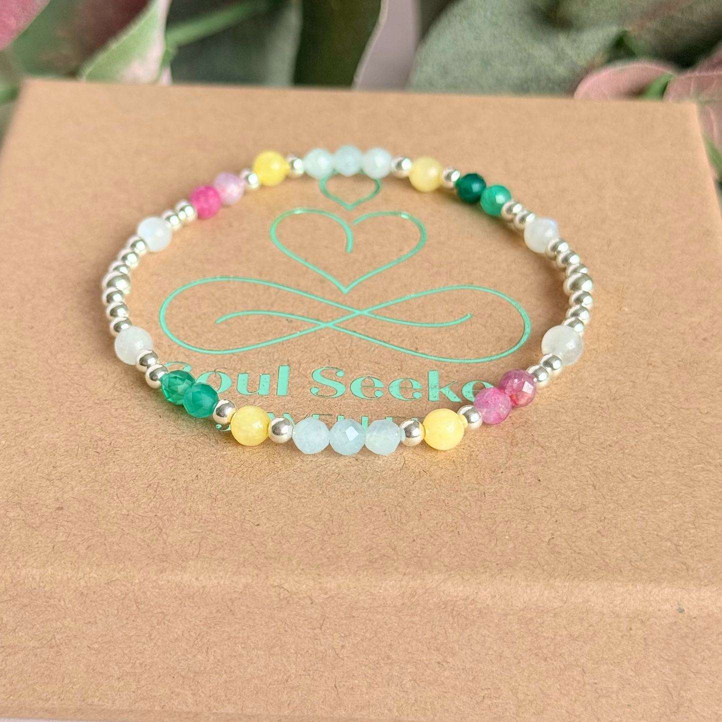 'Amalfi Coast' sterling silver dainty beaded bracelet with green agate, yellow calcite, pink tourmaline, aquamarine and moonstone. Made with round 3mm sterling silver beads and 4mm smooth and faceted round crystal gemstone beads. Pictured on top of the gift box