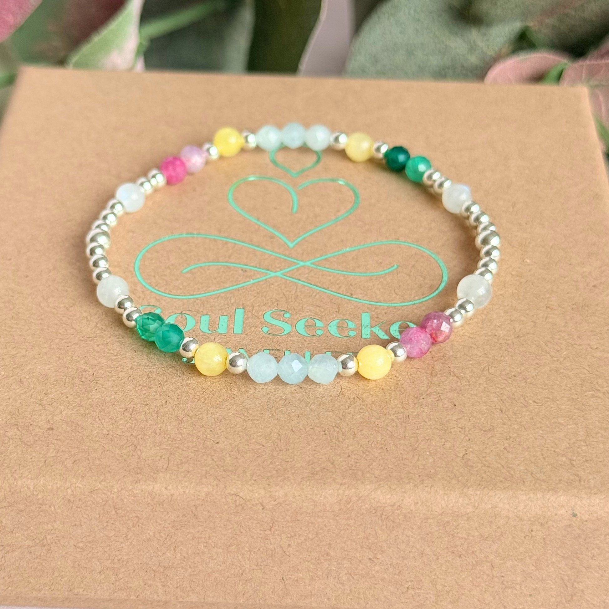'Amalfi Coast' sterling silver dainty beaded bracelet with green agate, yellow calcite, pink tourmaline, aquamarine and moonstone. Made with round 3mm sterling silver beads and 4mm smooth and faceted round crystal gemstone beads. Pictured on top of the gift box