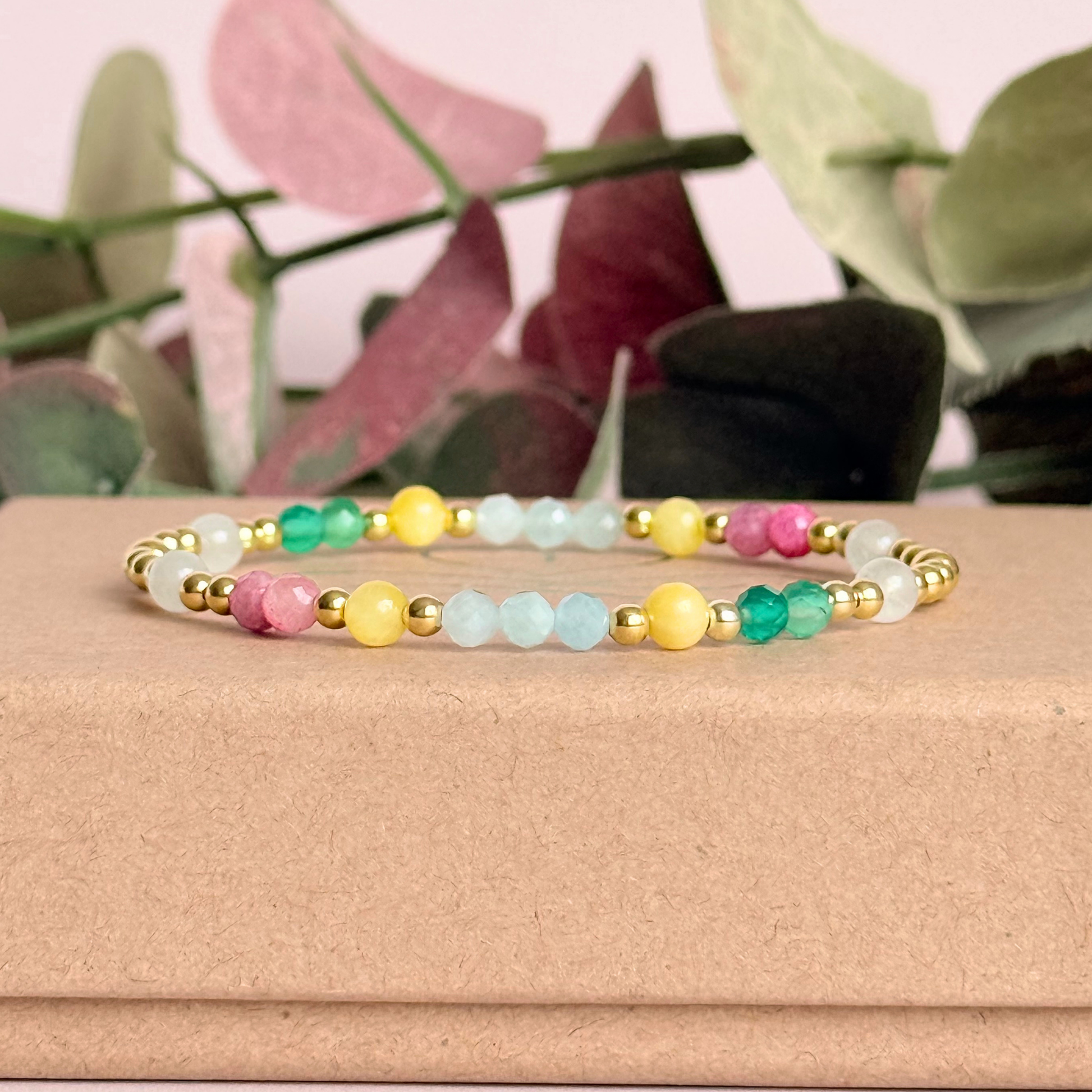 'Amalfi Coast' gold vermeil dainty beaded bracelet with green agate, yellow calcite, pink tourmaline, aquamarine and moonstone. Made with round 3mm gold vermeil beads and 4mm smooth and faceted round crystal gemstone beads. Pictured on top of the box