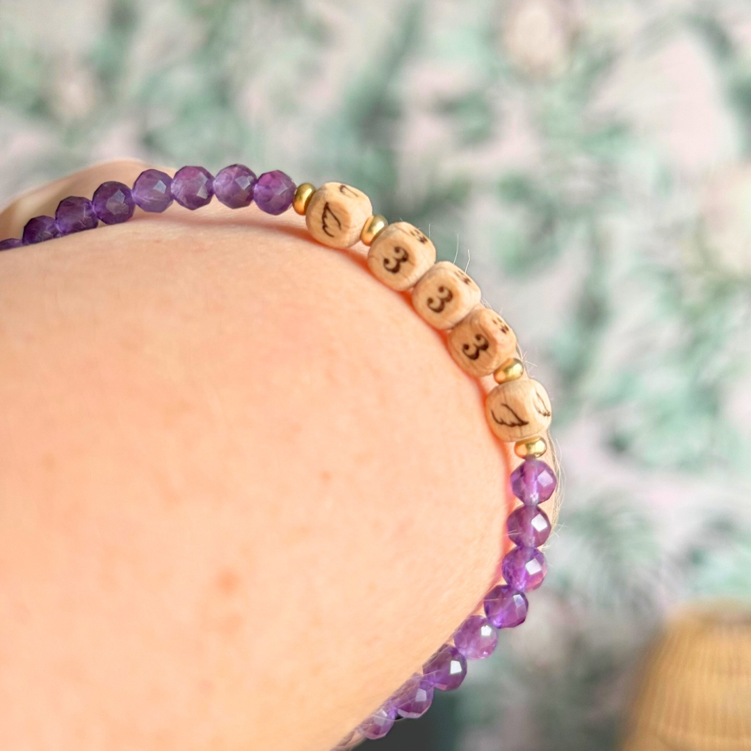 Bracelet featuring engraved wooden 333 angel number and wing beads, on the band of 4mm faceted amethyst round crystal gemstone beads. Finished with your choice of gold vermeil, sterling silver or rose gold vermeil accent beads.