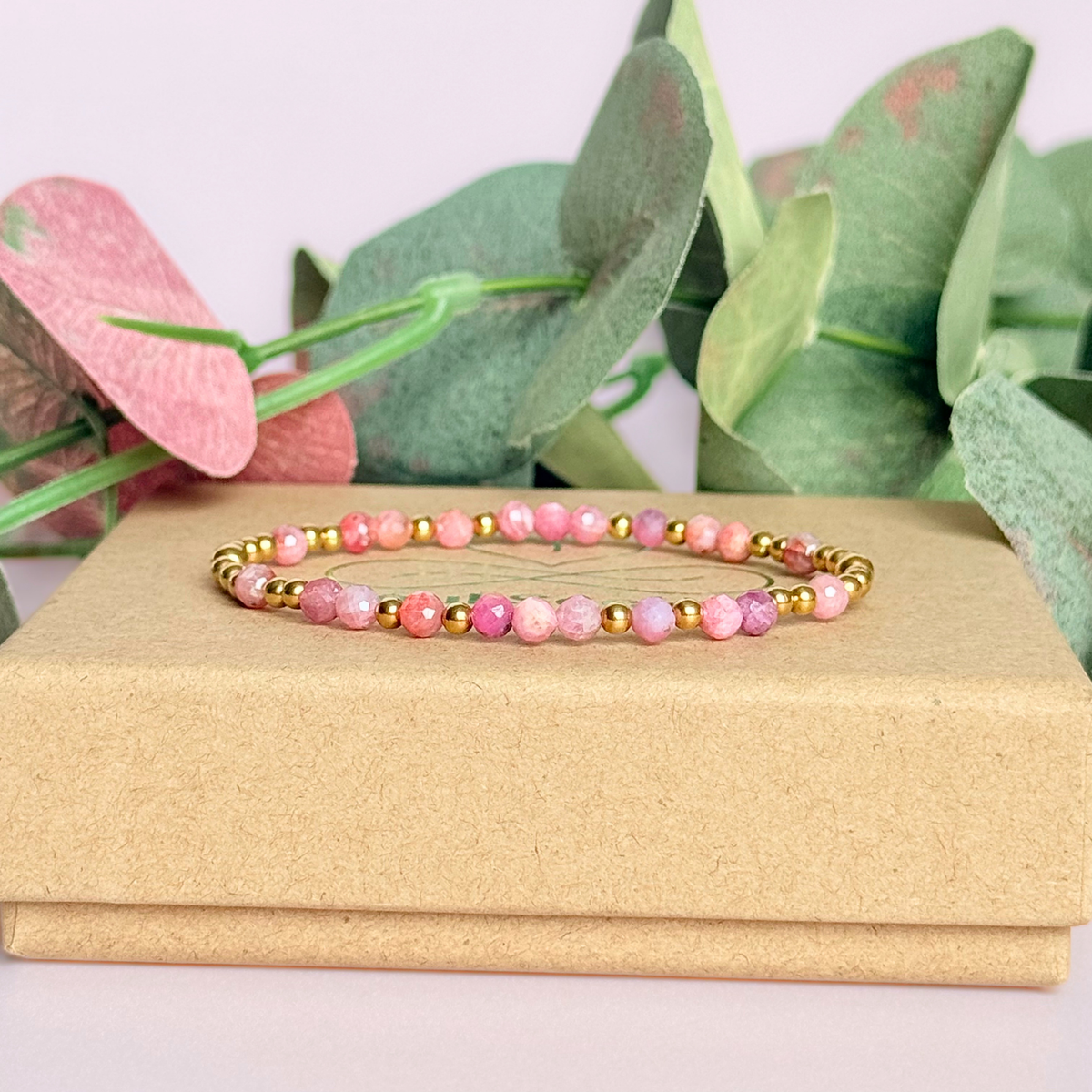 Dainty, minimalist gold vermeil and pink tourmaline October birthstone stacking bracelet. Made with 4mm faceted pink tourmaline beads and 3mm gold vermeil round beads. Elasticated for comfort. Pictured on the box