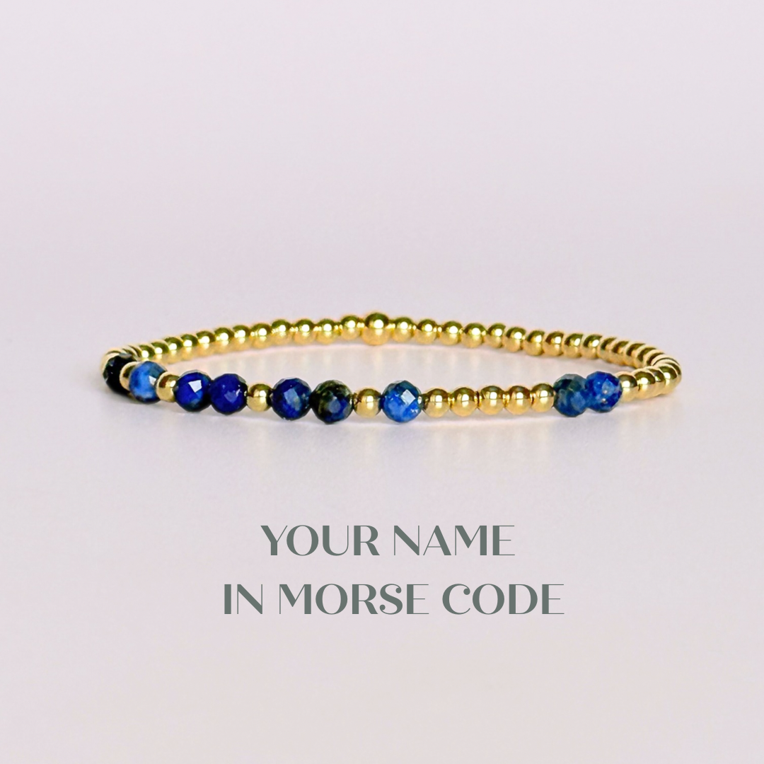 Morse code secret message bracelet spelling out your chosen name in gold filled and lapis lazuli crystal beads. Elasticated with 4mm faceted lapis lazuli beads and 3mm gold filled beads. Custom September birthstone bracelet.