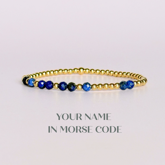 Morse code secret message bracelet spelling out your chosen name in gold filled and lapis lazuli crystal beads. Elasticated with 4mm faceted lapis lazuli beads and 3mm gold filled beads. Custom September birthstone bracelet.