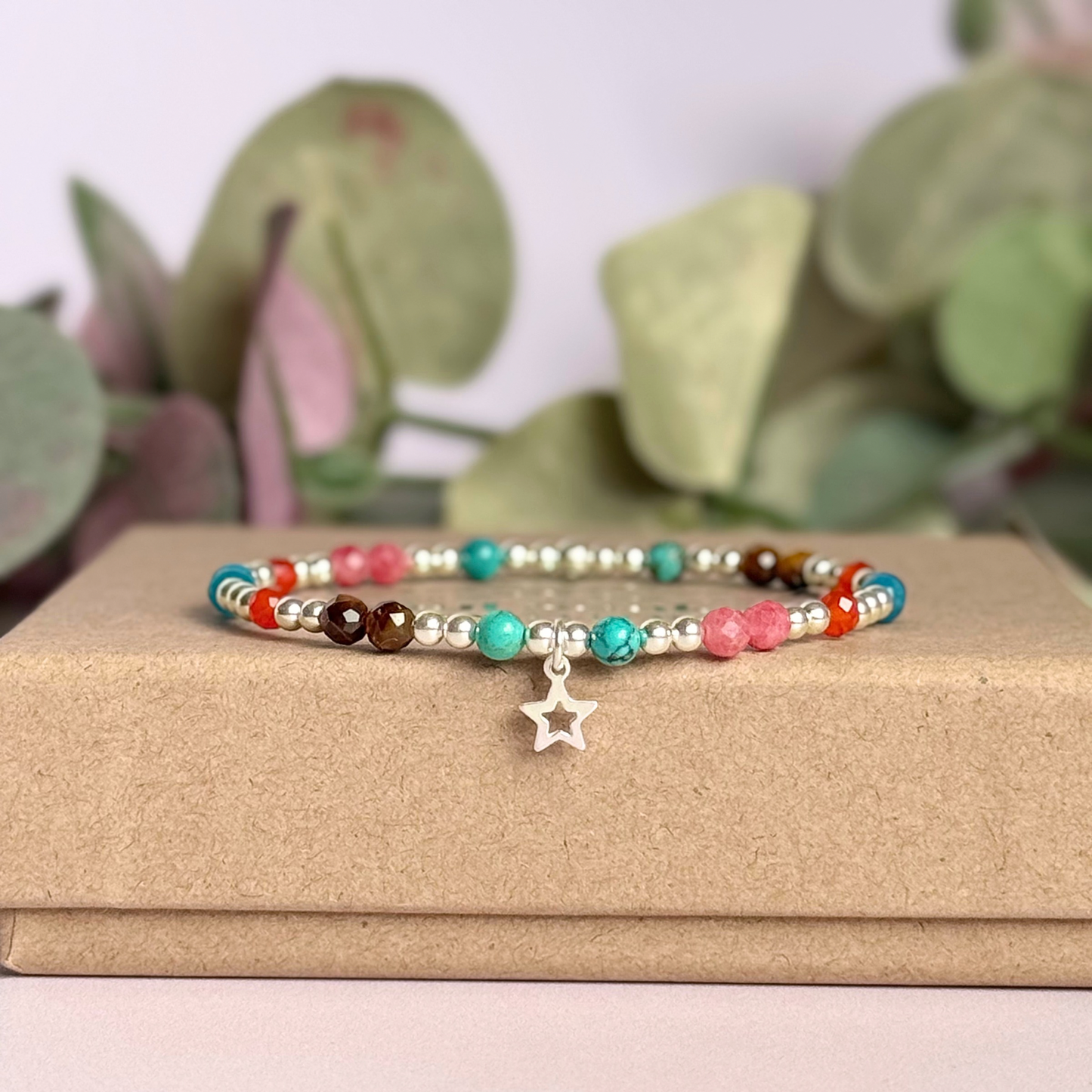 'Hot girl summer' sterling silver dainty beaded bracelet with tigers eye, turquoise, apatite, carnelian and rhodochrosite. With a beautiful open star charm. Made with round 3mm sterling silver beads and 4mm smooth and faceted round crystal gemstone beads. Pictured on the box.