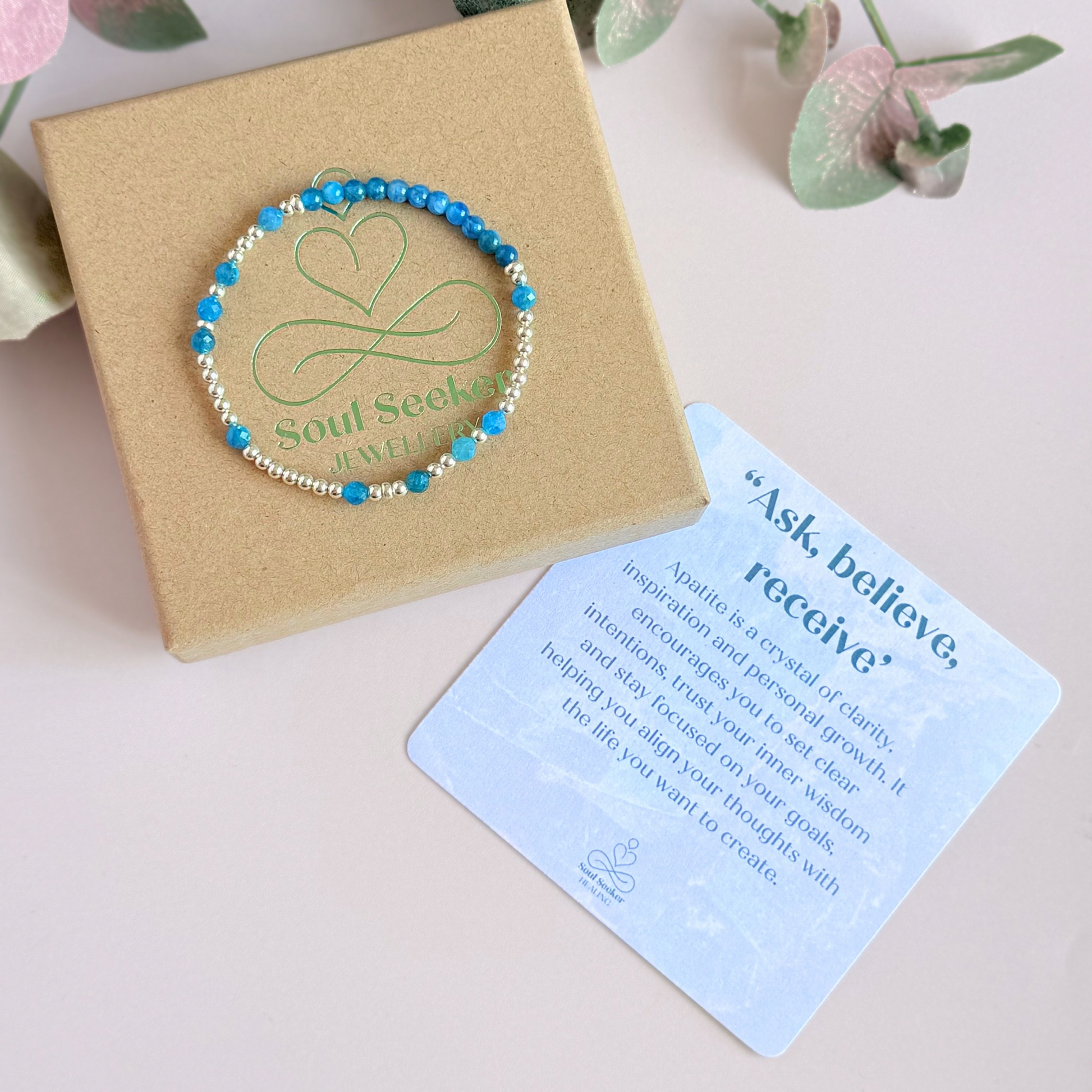 Apatite morse code bracelet that spells out the words ‘Ask, believe, receive’ in a combination of 4mm round smooth and faceted crystal beads with your choice of sterling silver or gold vermeil accent beads. Pictured in silver, on the gift box with the crystal information card