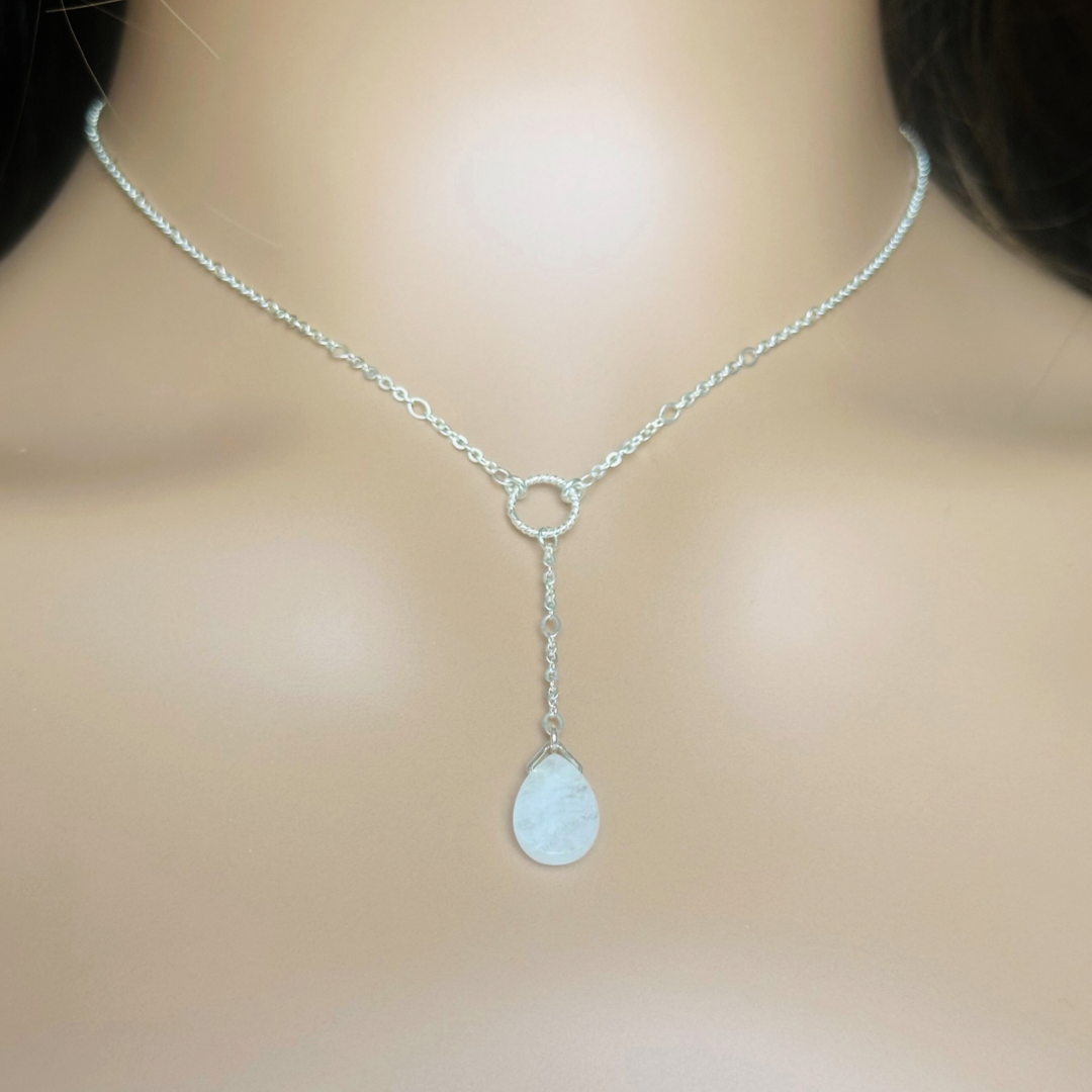 Moonstone necklace features a faceted moonstone teardrop bead on a delicate sterling silver figaro chain with a twisted sterling silver ring focal point. The necklace fastens with a subtle yet secure sterling silver bolt clasp. The teardrop bead measures 12mm x 8mm.