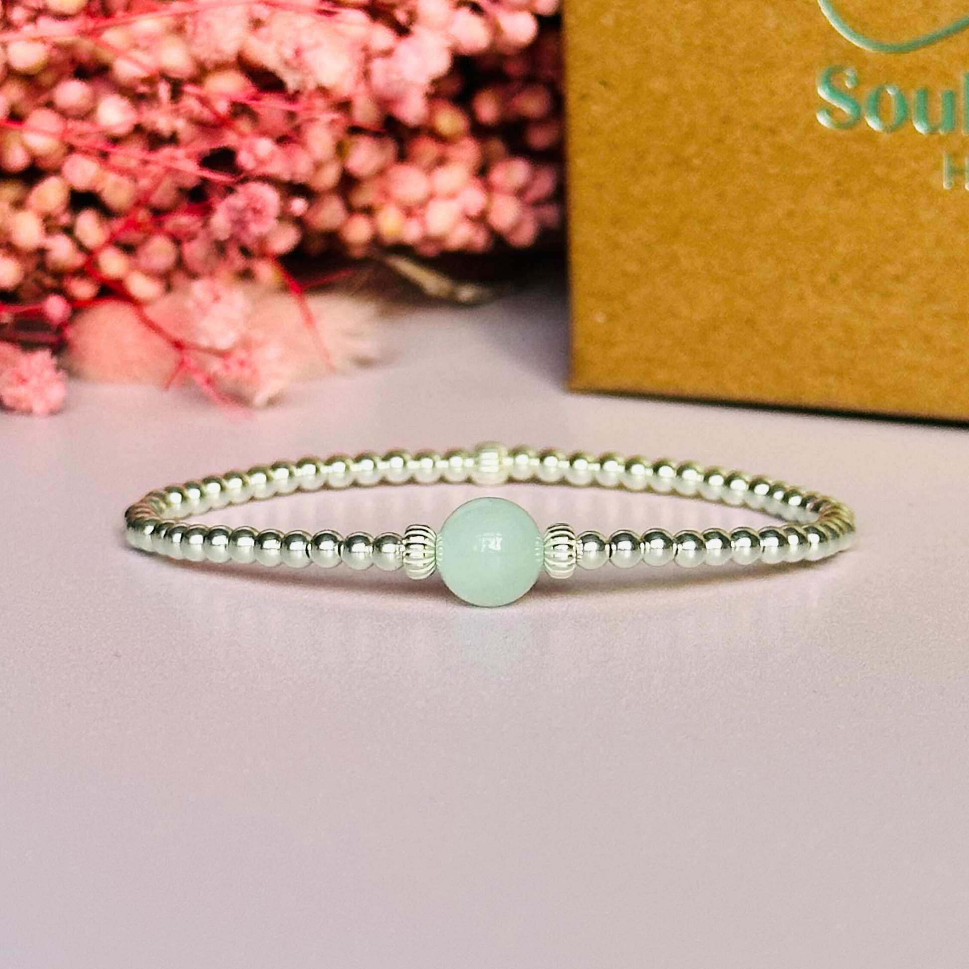 Sterling silver aquamarine bracelet features an ethically mined 8mm aquamarine bead, flanked by corrugated rondelle beads on a band of 3mm sterling silver beads. A bracelet to promote courage and self expression.