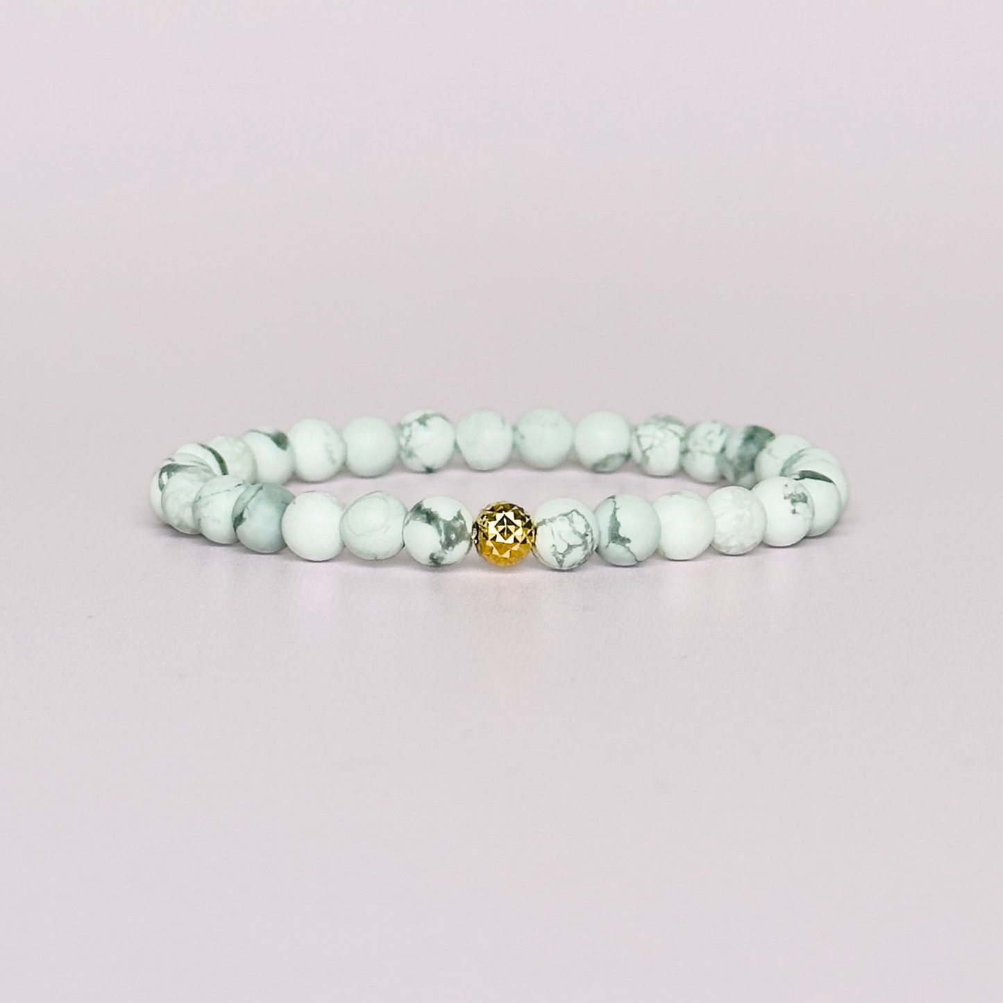 This howlite bracelet is made with ethically mined frosted howlite smooth crystal beads and features your choice of a sterling silver or gold vermeil faceted focal bead. A bracelet for emotional healing, calm and memory. All beads are 6mm.