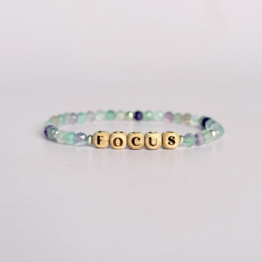 Bracelet featuring 5mm engraved wooden beads, which you can personalise with your choice of words, numbers and symbols. The main the band of the bracelet is made with 4mm faceted fluorite round crystal gemstone beads. Finished with your choice of gold vermeil, sterling silver or rose gold vermeil accent beads.