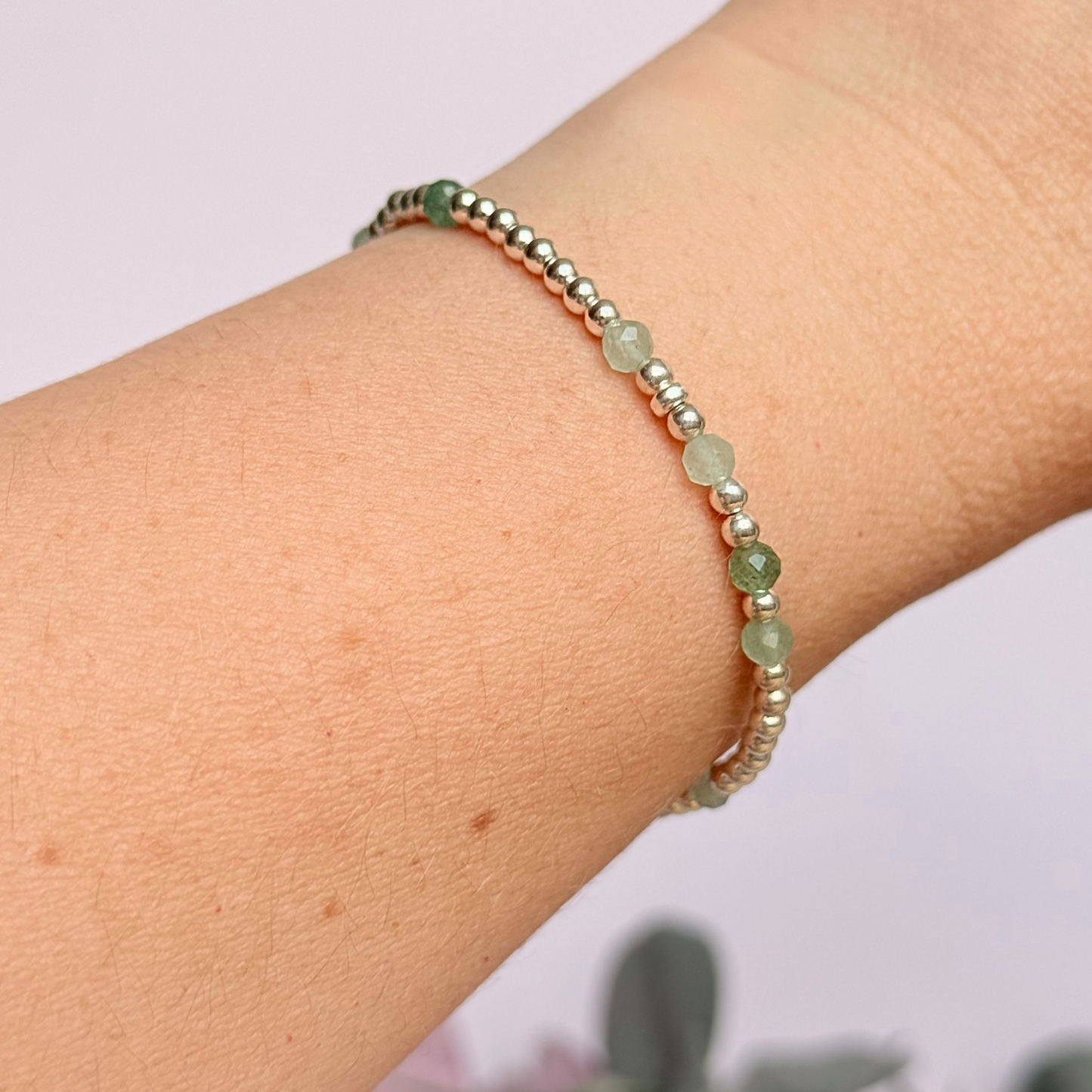 Green aventurine morse code bracelet that spells out the words ‘Ask, believe, receive’ in a combination of 4mm round smooth and faceted crystal beads with your choice of sterling silver or gold vermeil accent beads. Pictured in silver, being worn