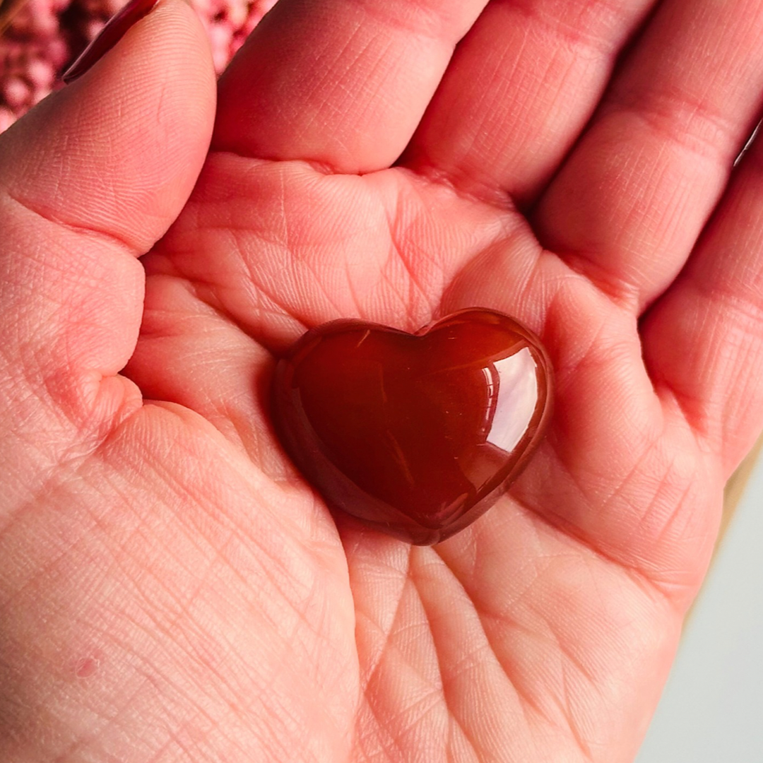 A beautiful ethically mined carnelian heart, presented on an eco-friendly textured card with the words 'A stone for creativity, vitality and confidence.' This heart shaped carnelian crystal measures approximately 25mm x 25mm.