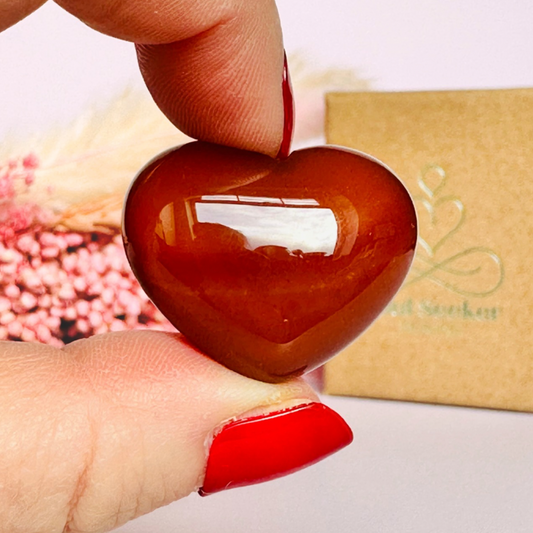 A beautiful ethically mined carnelian heart, presented on an eco-friendly textured card with the words 'A stone for creativity, vitality and confidence.' This heart shaped carnelian crystal measures approximately 25mm x 25mm.