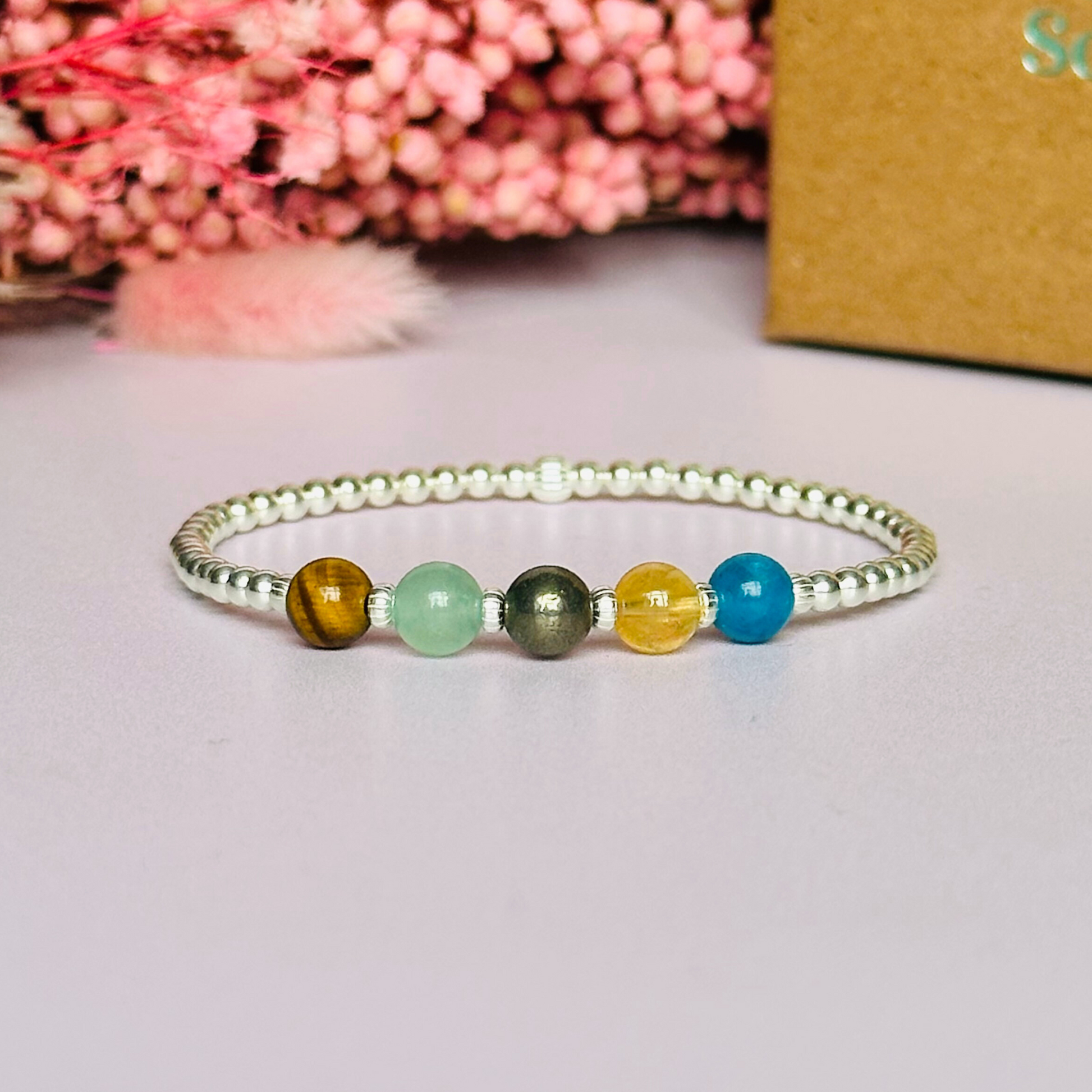 This sterling silver manifesting bracelet is made with a selection of five healing crystals all believed to help achieve your dream life. The crystal beads are all 6mm and are on a band of 3mm sterling silver beads with corrugated accent beads.