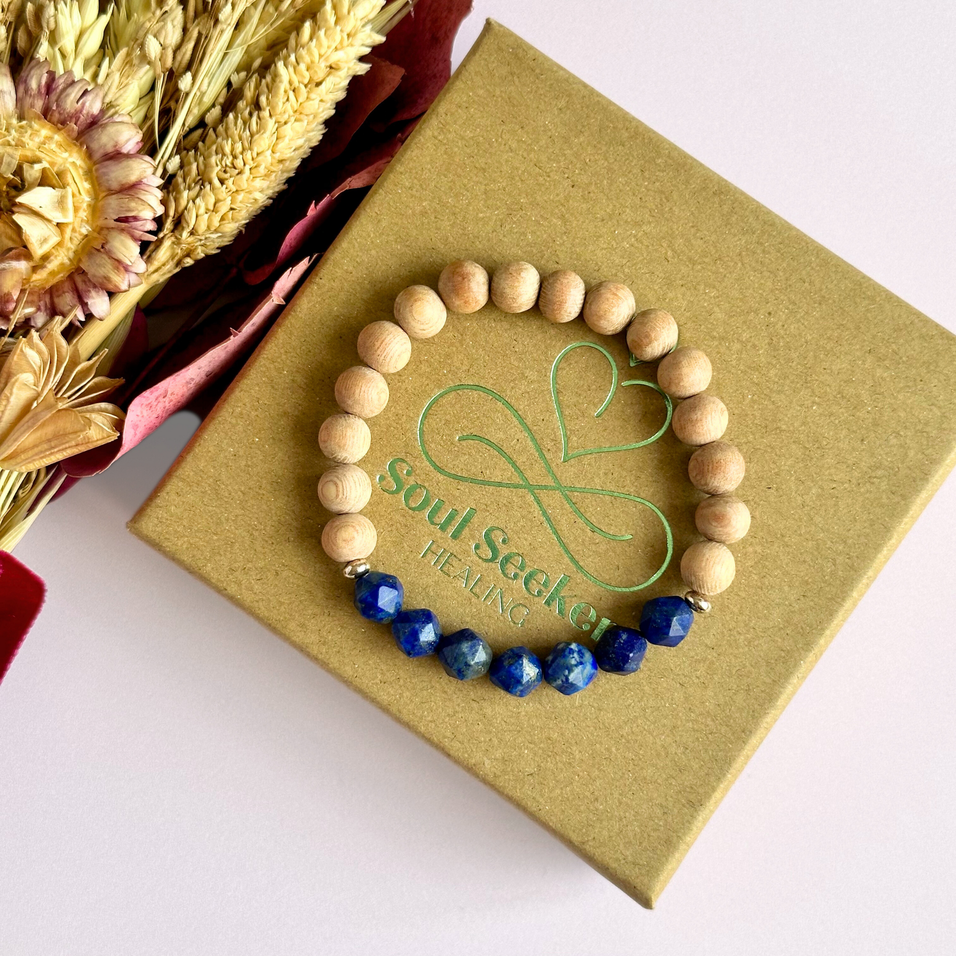 Lapis lazuli and raw rosewood elasticated essential oil diffuser bracelet. Made with 8mm star cut lapis lazuli beads, 8mm round raw rosewood beads and your choice of sterling silver, gold vermeil or rose gold vermeil spacer beads