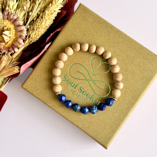 Lapis lazuli and raw rosewood elasticated essential oil diffuser bracelet. Made with 8mm star cut lapis lazuli beads, 8mm round raw rosewood beads and your choice of sterling silver, gold vermeil or rose gold vermeil spacer beads