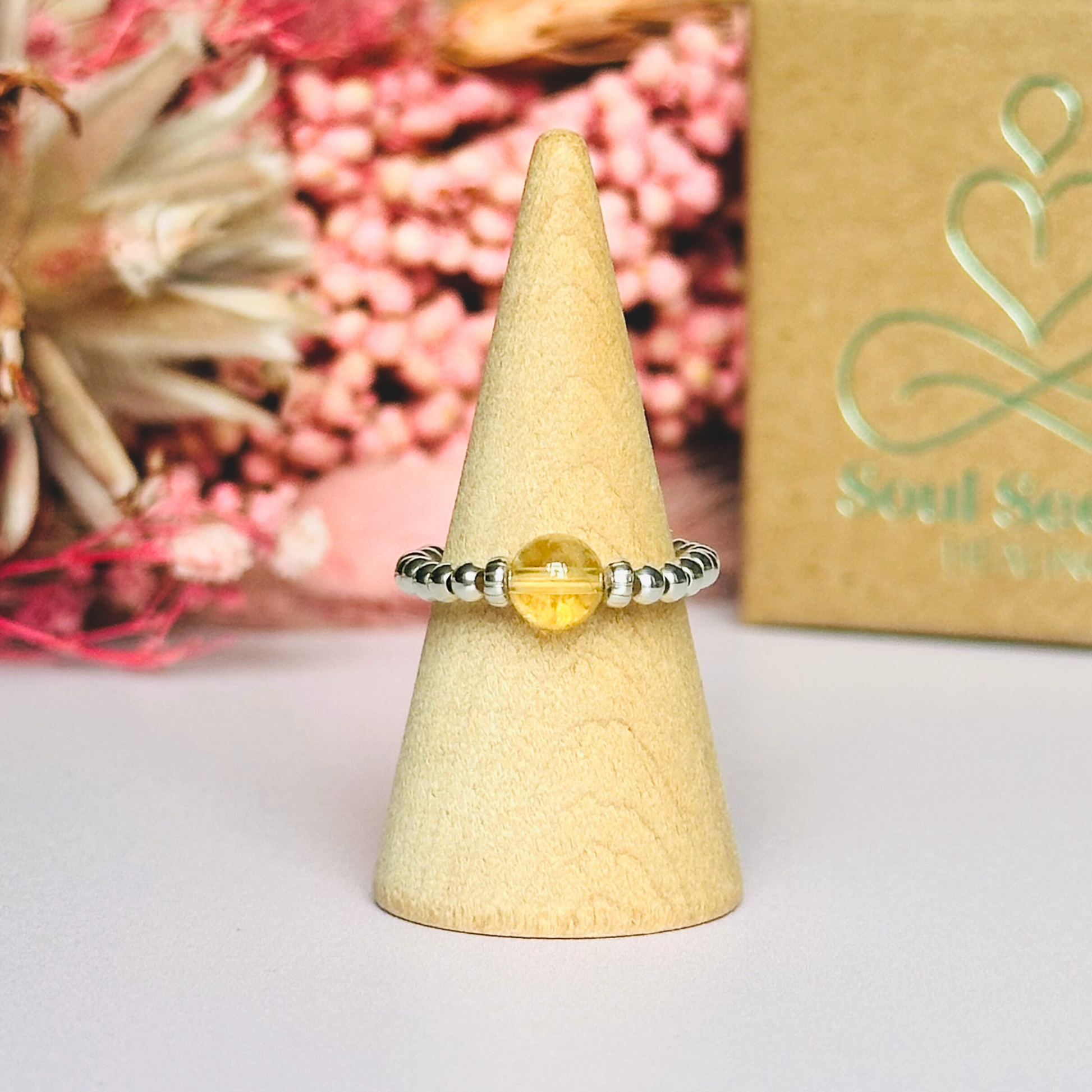 Citrine ring featuring a 6mm round citrine bead, flanked by sterling silver rondelle beads on a sterling silver elasticated band. November birthday ideas, November birthday gift, November birthstone ring, November jewellery, born in November
