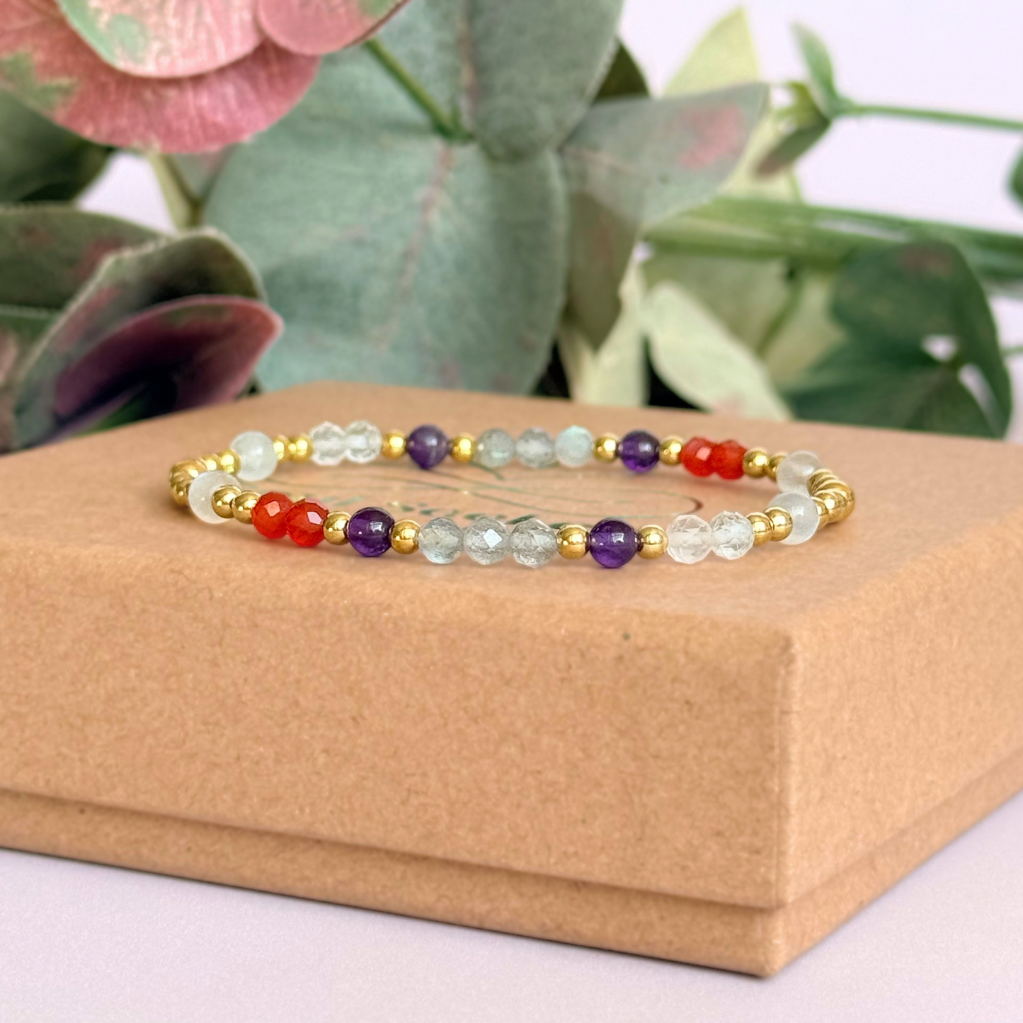 Dainty gold vermeil crystal bracelet featuring five crystals, in 4mm faceted and smooth round style, each believed to help with hormonal balance. Featuring amethyst, moonstone, carnelian, labradorite and rose quartz. Pictured on top of the gift box.