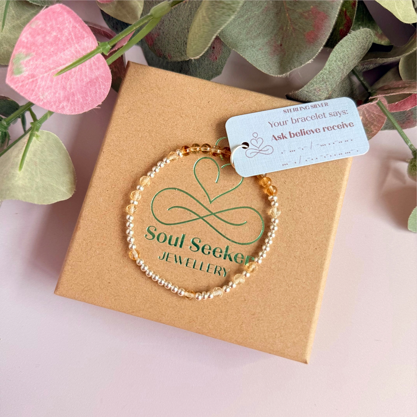 Citrine morse code bracelet that spells out the words ‘Ask, believe, receive’ in a combination of 4mm round smooth and faceted crystal beads with your choice of sterling silver or gold vermeil accent beads. Pictured in silver, on the gift box