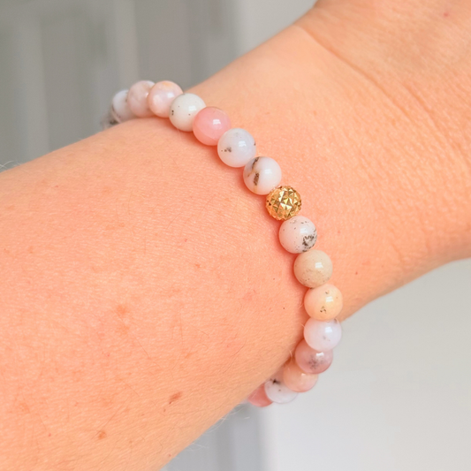 Pink opal bracelet featuring 6mm genuine round pink opal beads, with one faceted gold vermeil 6mm bead as the focal point. Elasticated for comfort.
