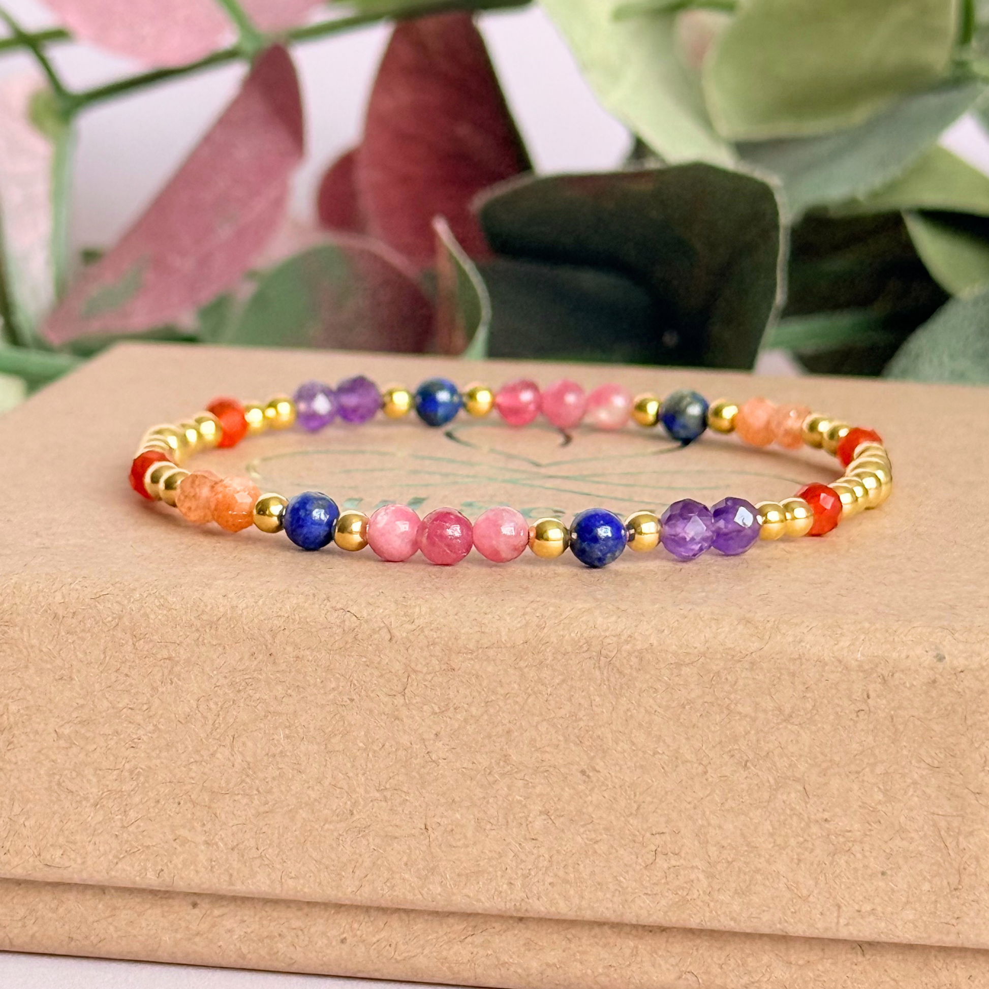 ‘Arabian Sunset' gold vermeil dainty beaded bracelet with pink tourmaline, sunstone, carnelian, lapis lazuli and amethyst. Made with round 3mm gold vermeil beads and 4mm smooth and faceted round crystal gemstone beads. Pictured on top of the gift box