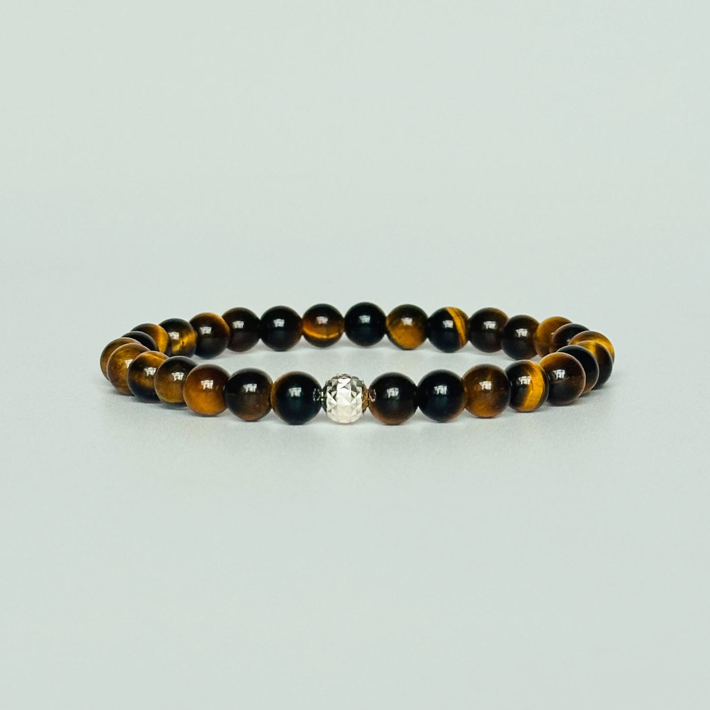 Tigers Eye bracelet featuring 6mm smooth tiger eye beads. With your choice of gold vermeil or sterling silver faceted accent beats.