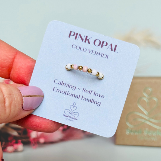 Birthstone ring featuring 5 3mm. Faceted Peruvian pink opal beads on an elasticated band of 3mm gold vermeil round beads, pink opal is an October birth stone so this makes a perfect October birthday gift.