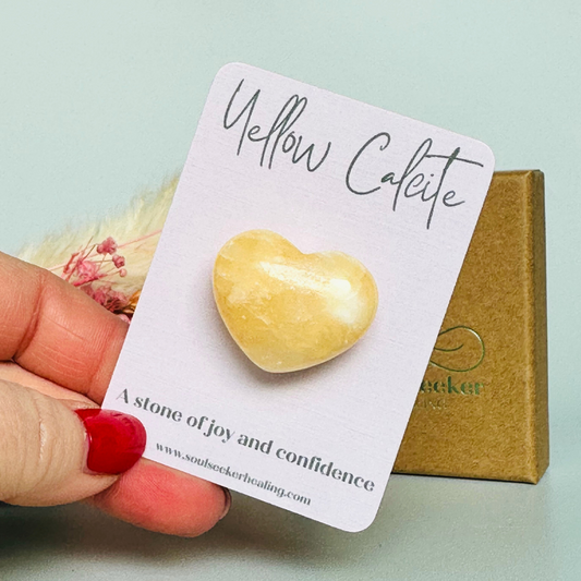 A beautiful ethically mined yellow calcite heart, presented on an eco-friendly textured card with the words 'A stone of joy and confidence.' This heart shaped crystal measures approximately 25mm x 25mm.