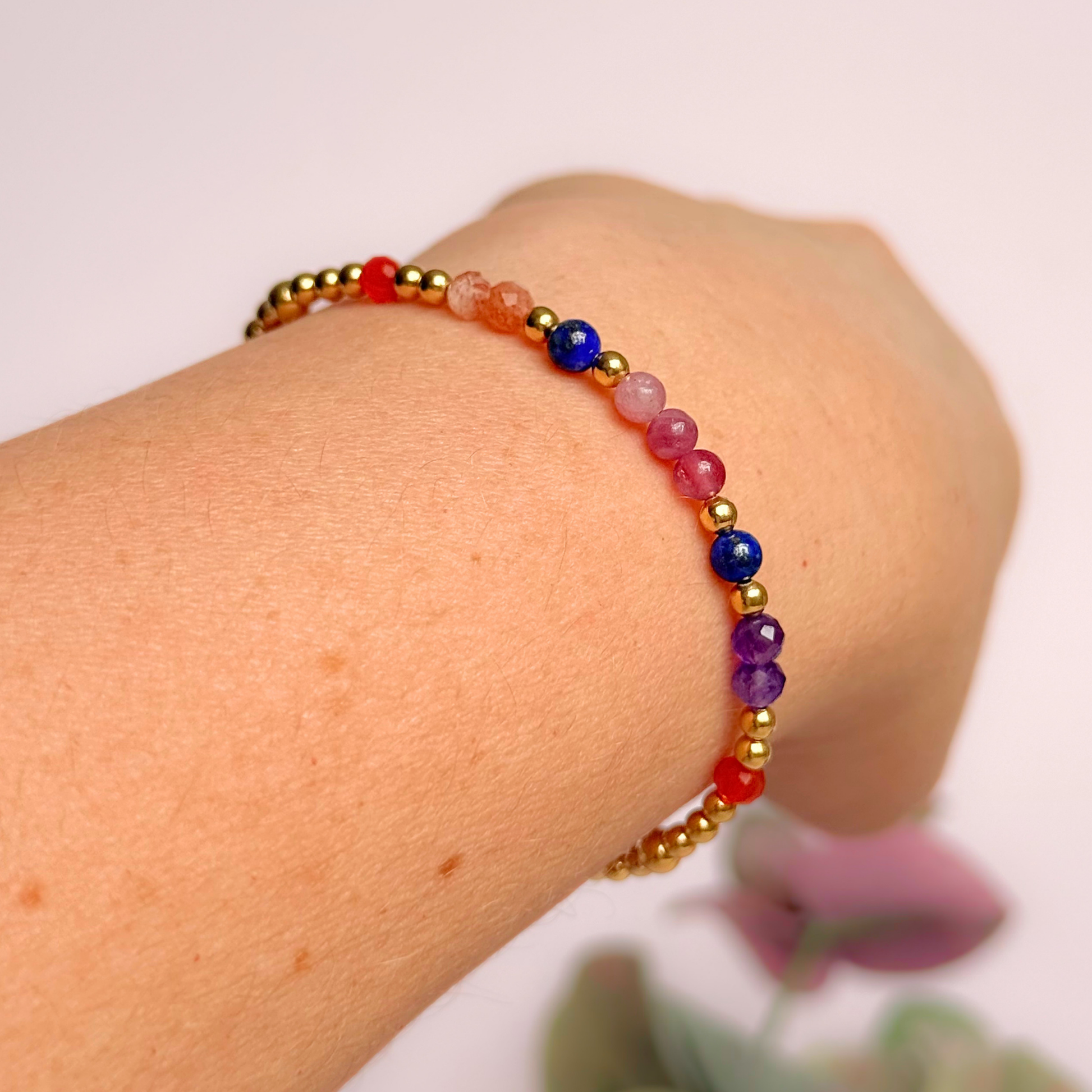 ‘Arabian Sunset' gold vermeil dainty beaded bracelet with pink tourmaline, sunstone, carnelian, lapis lazuli and amethyst. Made with round 3mm gold vermeil beads and 4mm smooth and faceted round crystal gemstone beads. Pictured being worn, at an angle