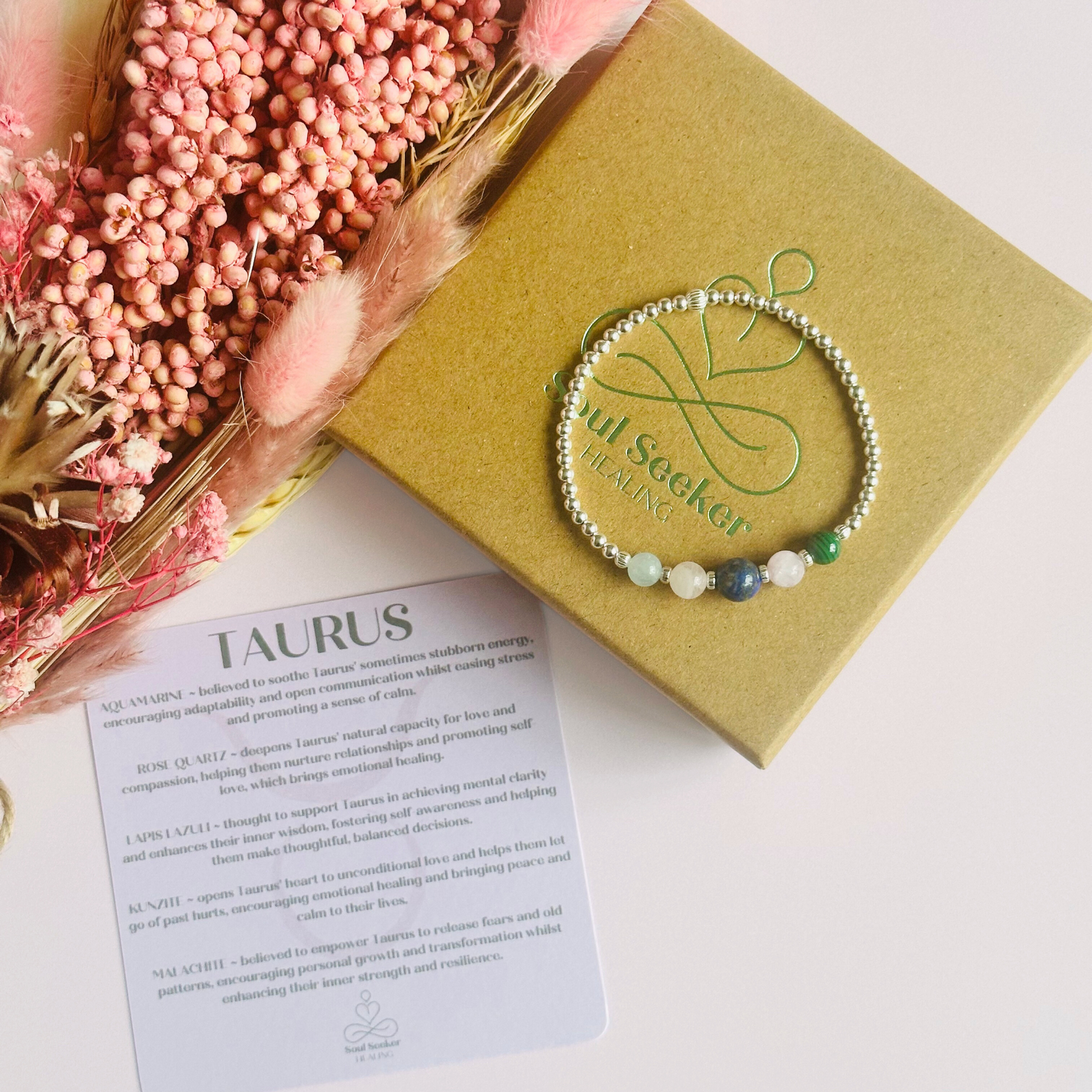 This sterling silver Taurus bracelet is made with a selection of five healing crystals all believed to resonate with the Taurus zodiac sign. The central bead is 8mm, the other four are 6mm. On an elasticated band of 3mm sterling silver beads with corrugated accent beads. Featuring malachite, lapis lazuli, rose quartz, kunzite and aquamarine.