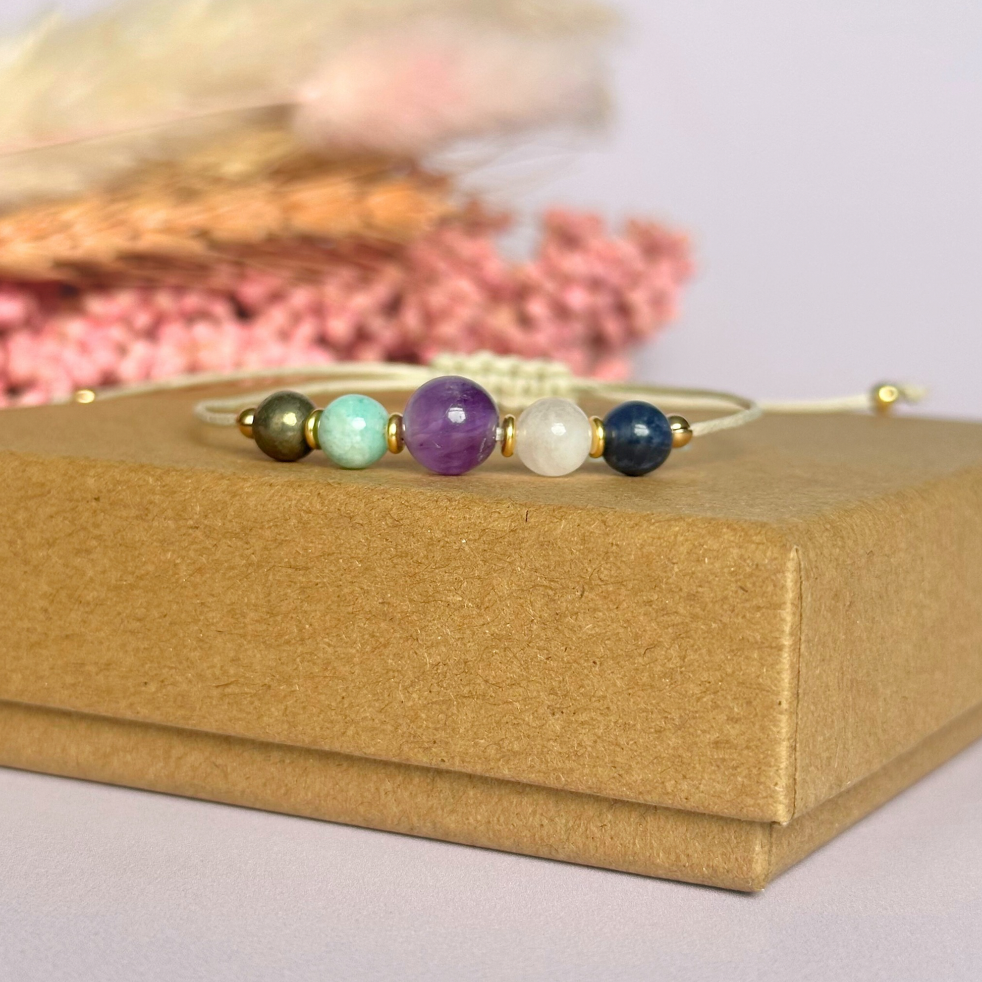 Eco-friendly, waxed cotton cord crystal healing bracelet featuring five crystals each believed to help deal with anxiety. Includes pyrite, amazonite, amethyst, rose quartz and sodalite. Adjustable as it fastens with a sliding macramé clasp. Choose from either sterling silver, gold vermeil or rose gold vermeil accent beads.