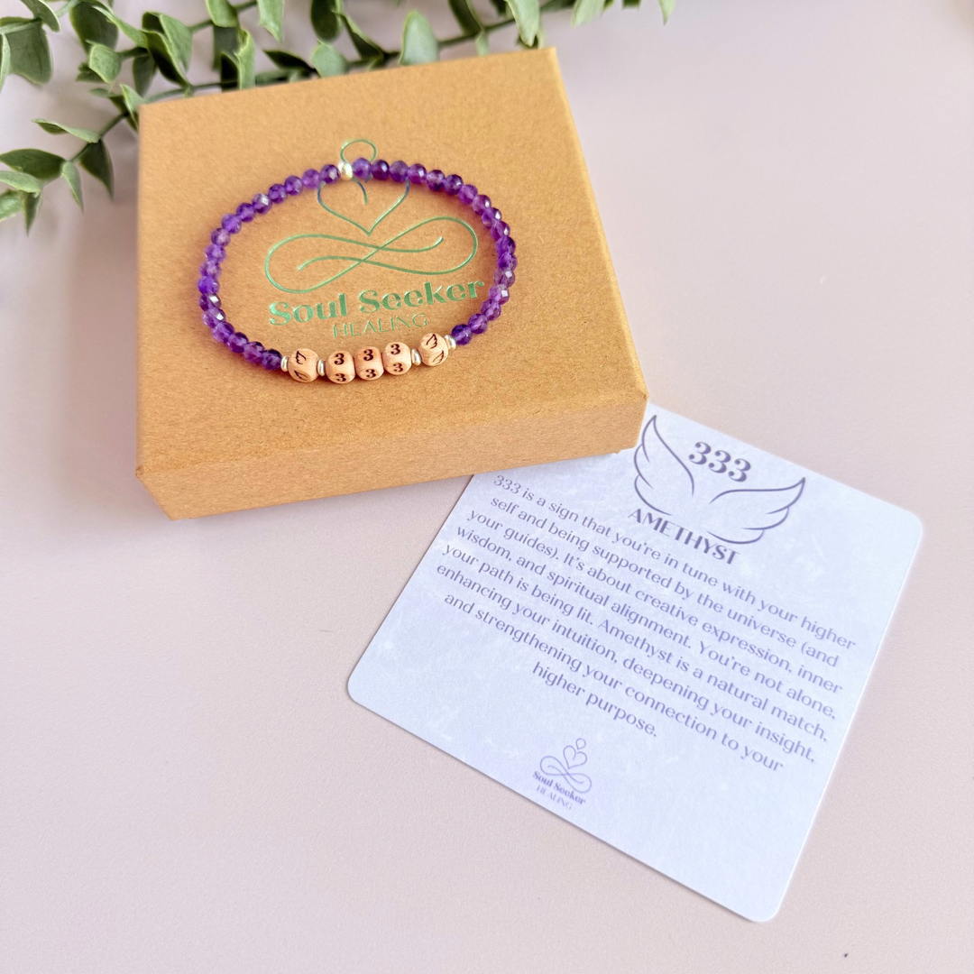 Bracelet featuring engraved wooden 333 angel number and wing beads, on the band of 4mm faceted amethyst round crystal gemstone beads. Finished with your choice of gold vermeil, sterling silver or rose gold vermeil accent beads.