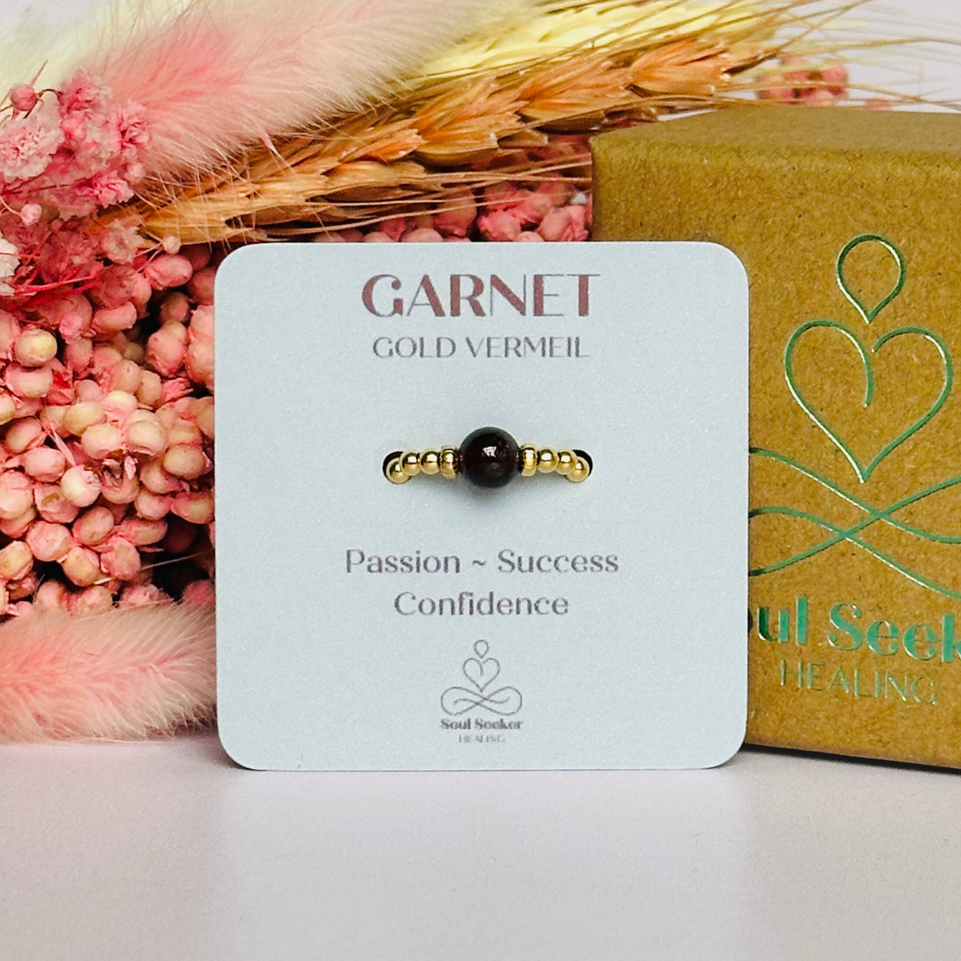 Gold vermeil garnet ring featuring a 6mm smooth round garnet bead on a elasticated ring band of 2.5mm gold vermeil beads.