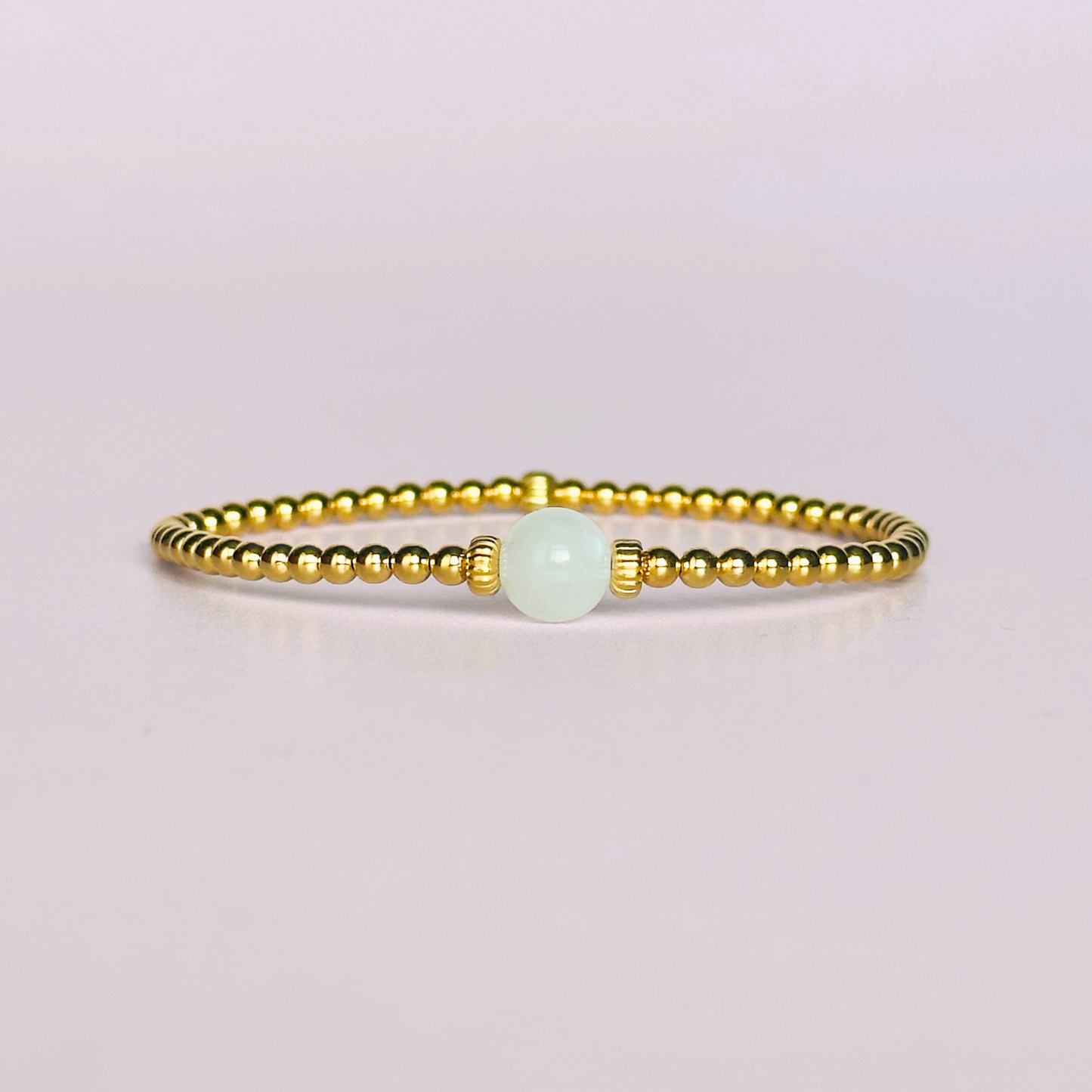 Gold vermeil moonstone bracelet features an ethically mined 8mm moonstone bead, flanked by corrugated rondelle beads on a band of 3mm gold vermeil beads. A bracelet to promote feminine energy and intuition.